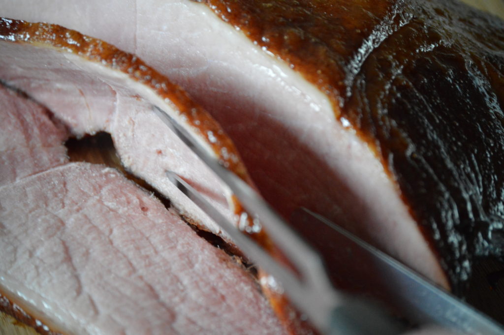 carving up the glazed ham