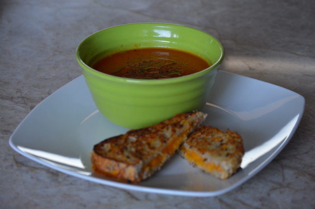 the finished tomato soup with a grilled cheese sandwhich