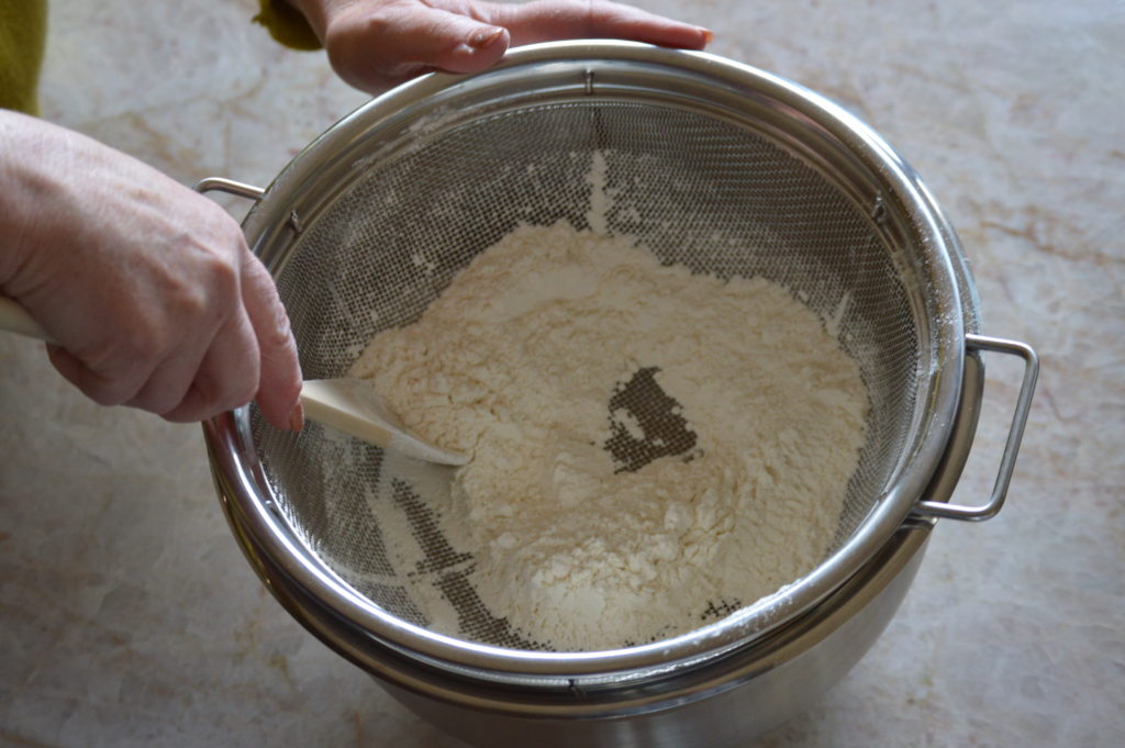 sifting the dry ingredients through a sieve