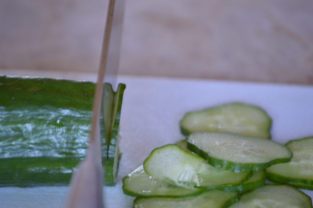slicing the cucumber thin