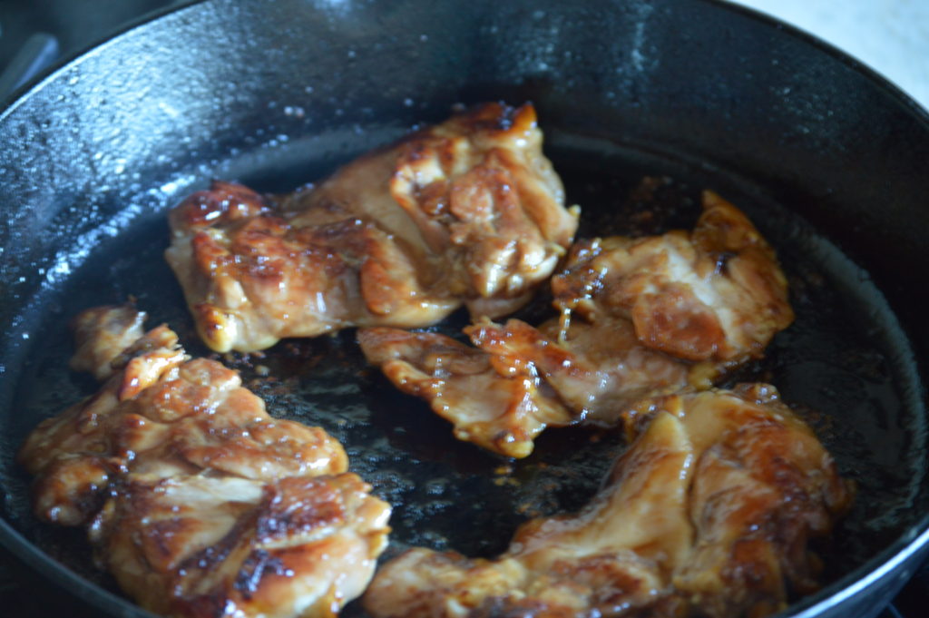 cooking the teriyaki chicken in a cast iron skillet