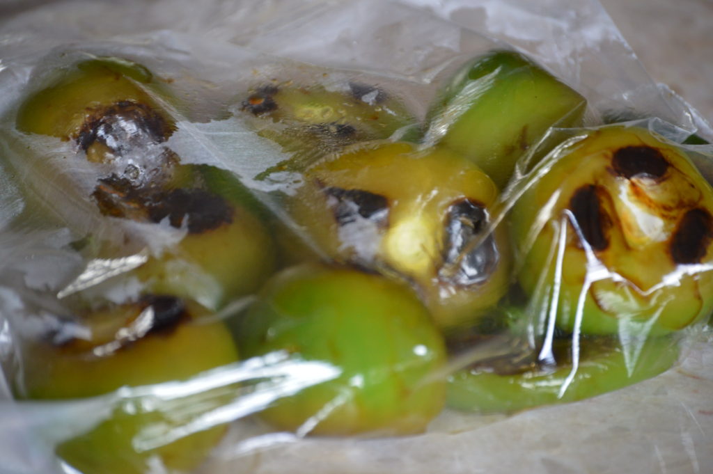 the tomatillos and chilies steaming in a plastic bag