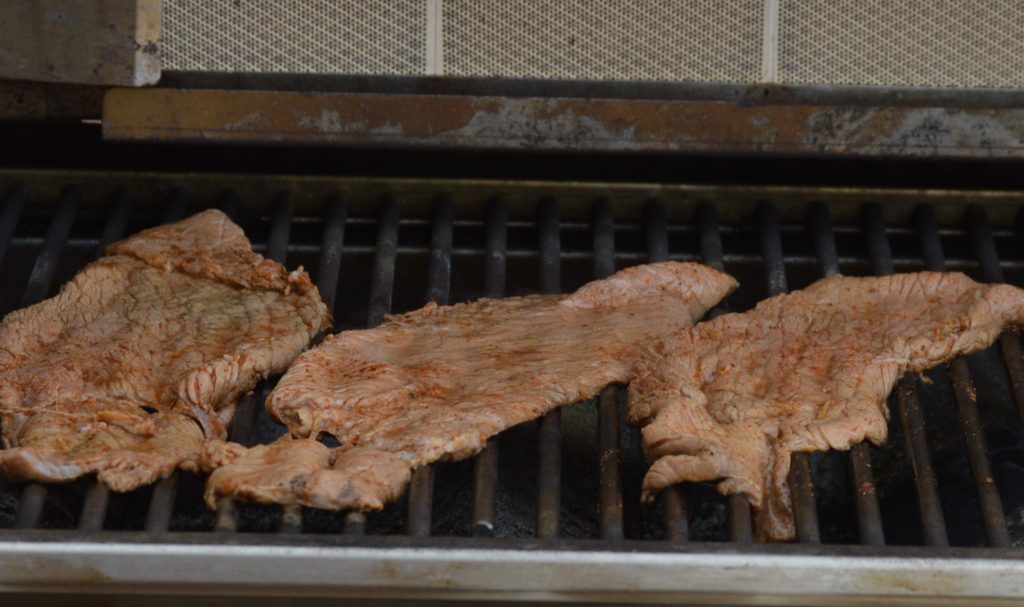 grilling the carne asada