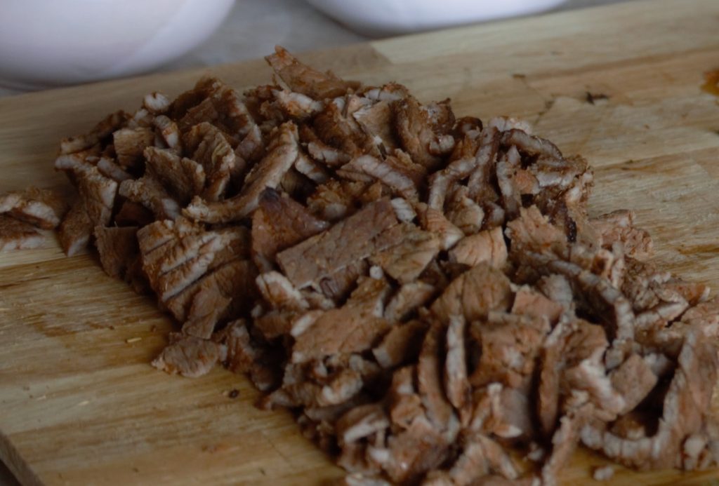 chopping up the carne asada