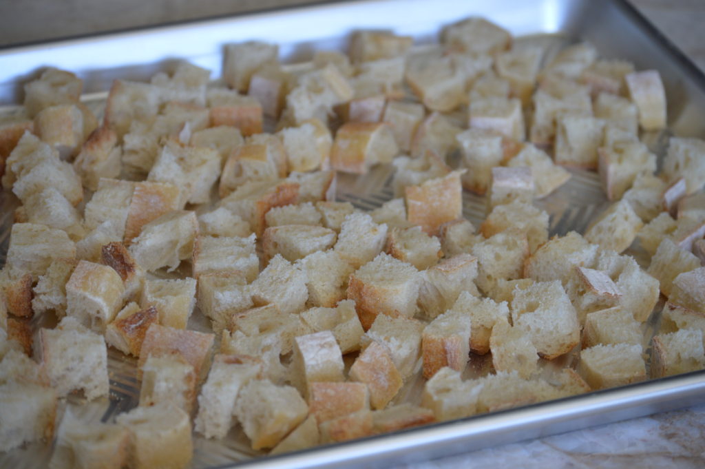 the cubed bread on a baking sheet