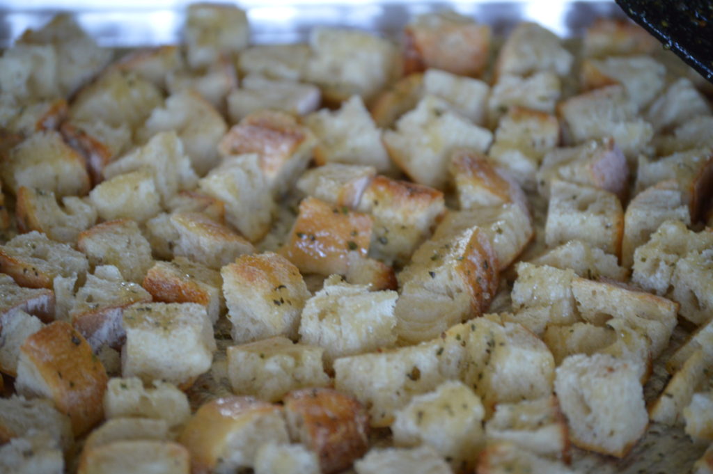 the bread cubes coated in oil and herbs