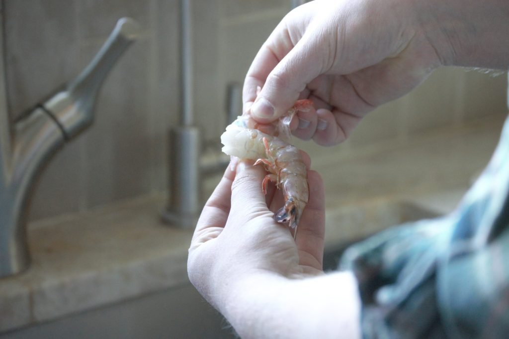 peeling the outer shell of the shrimp