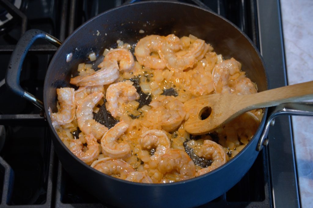 Two minutes later the butter has melted, and has coated the shrimp with all of the spices