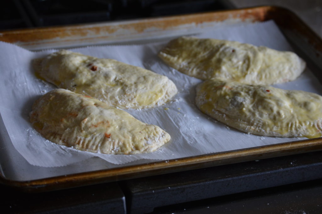 The calzones with egg wash and ready to go into the oven