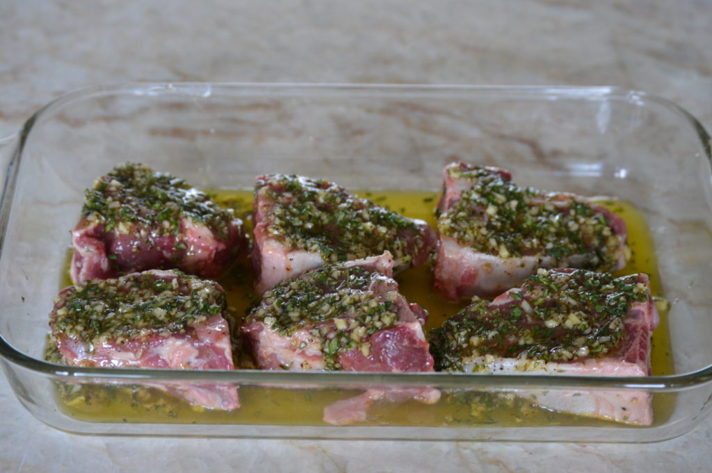 The marinate being applied to the chops