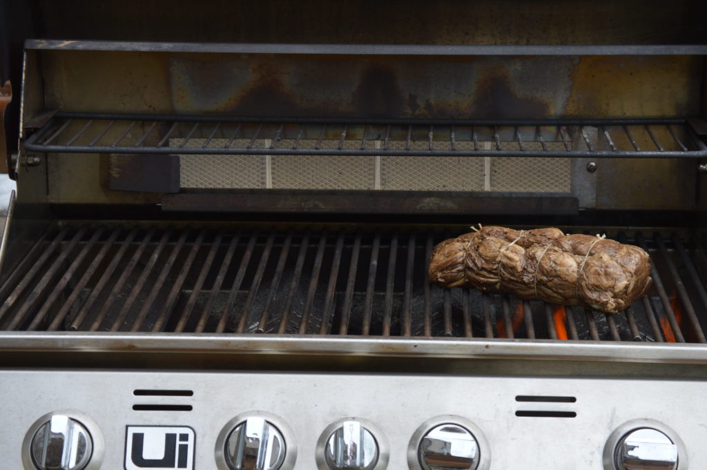 the beef over the grill flame