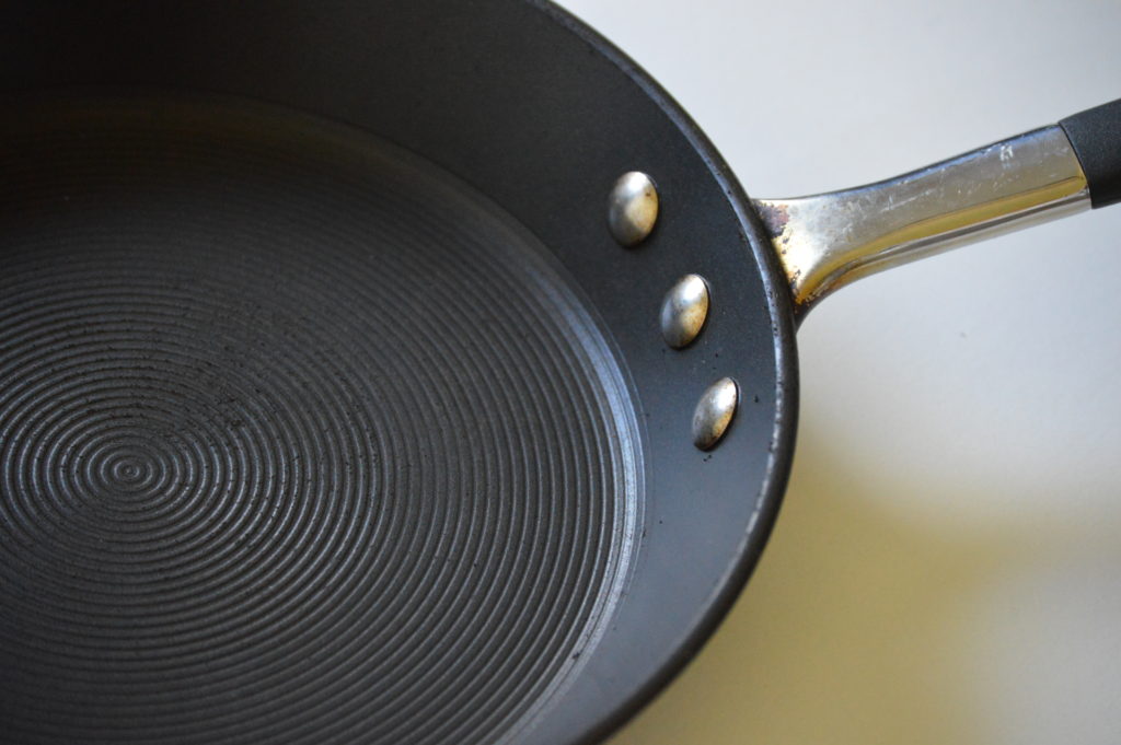The side of a frying pan cookwaer showing it's flaired sides