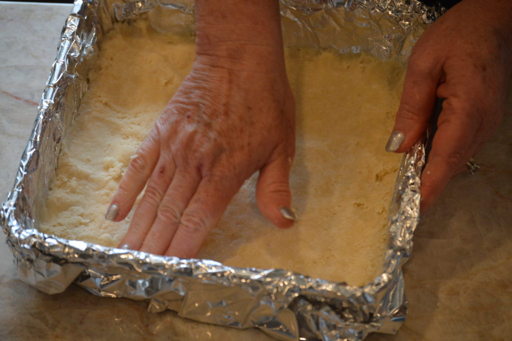 adding the pastry base to the baking pan