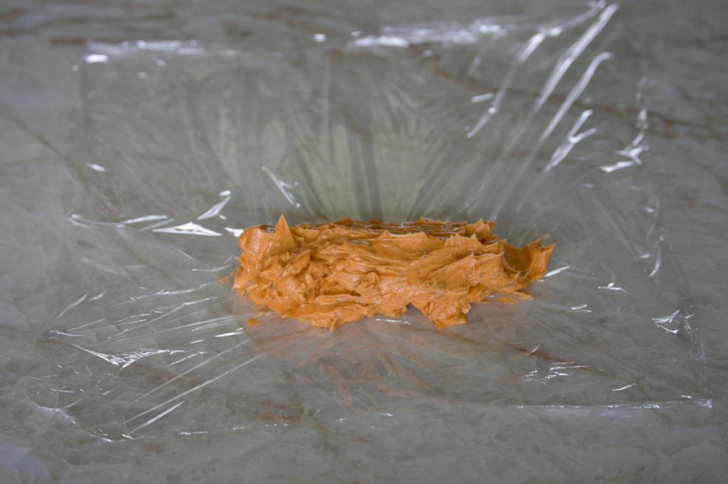laying the compound butter out on a sheet of plastic wrap
