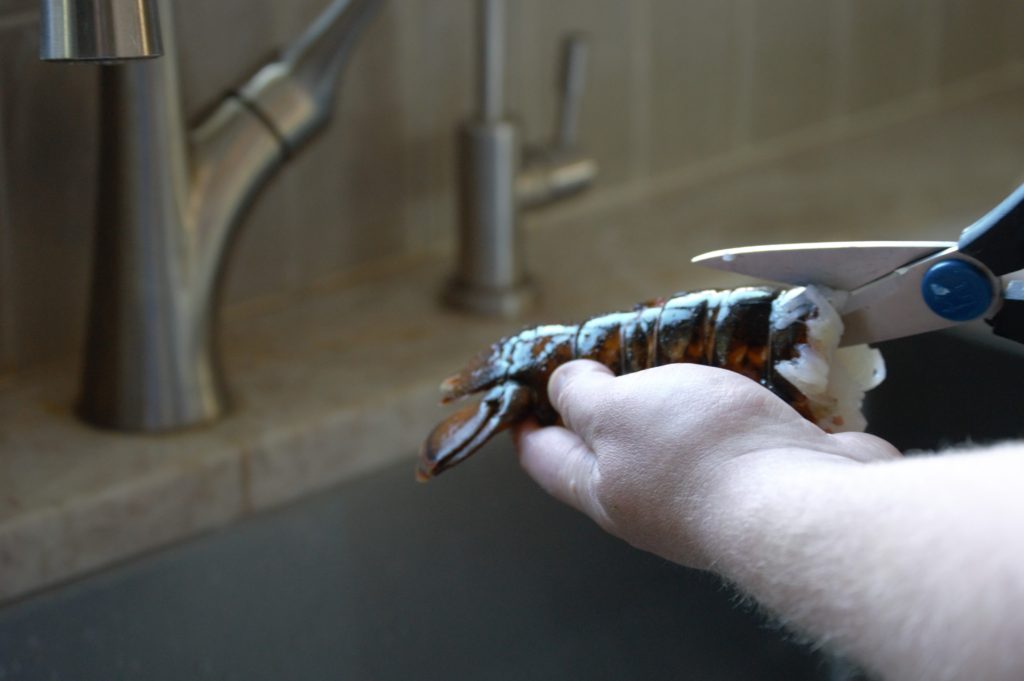 lobster tail being cut from other side