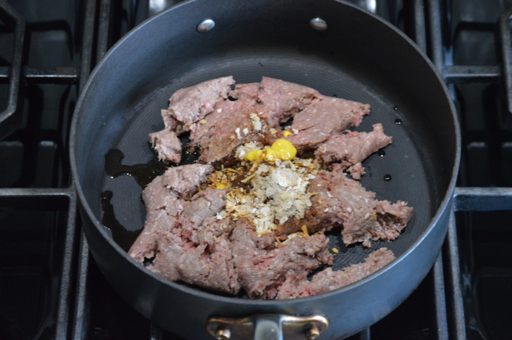 the ground beef and seasoning in a pan