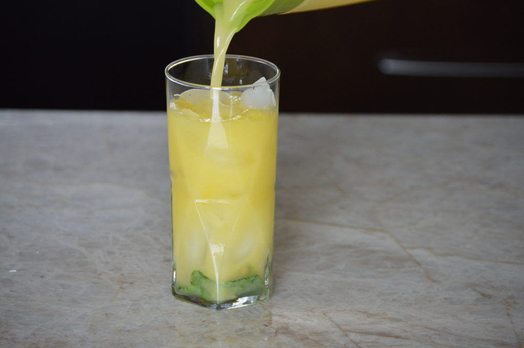 mango mojito mixture added to glass