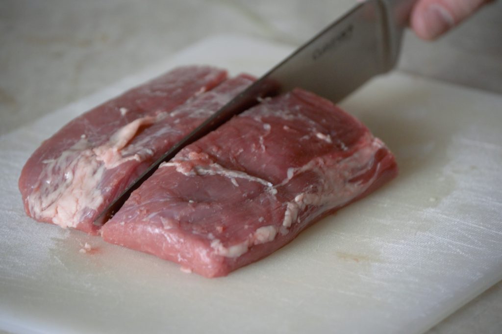 cutting the flank steak in half