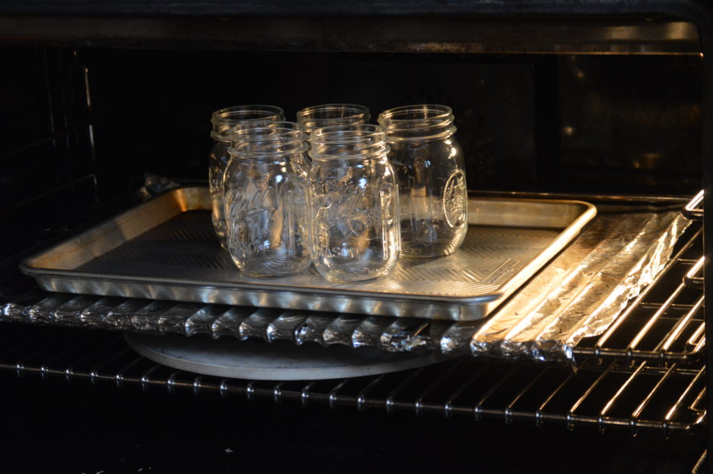 the mason jars sanitizing in the oven