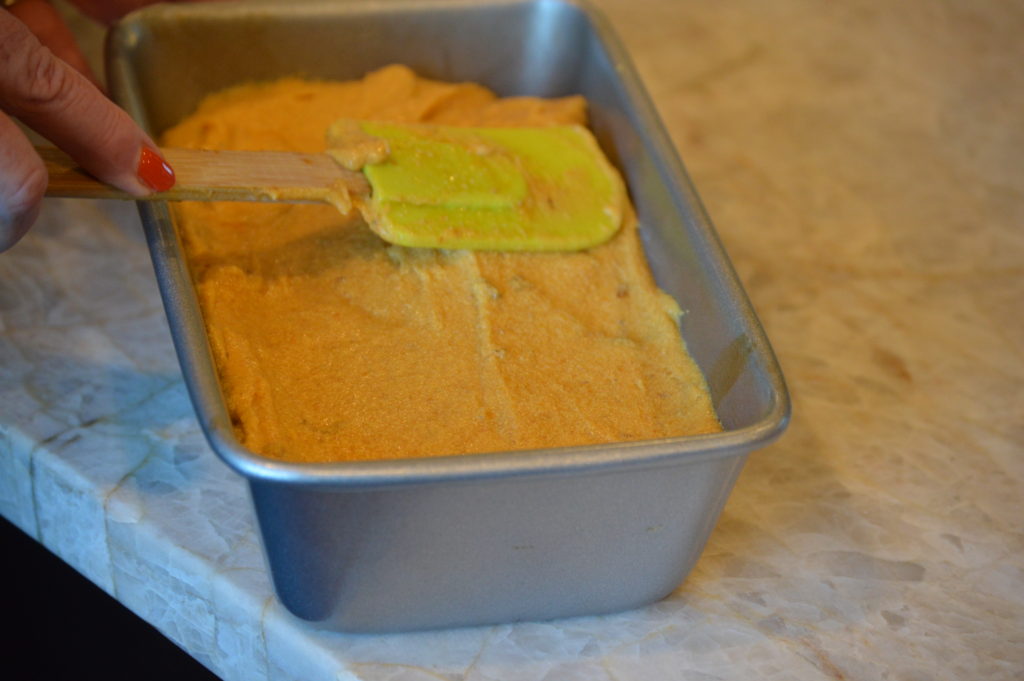 the pumpkin bread dough poured into a loaf pan