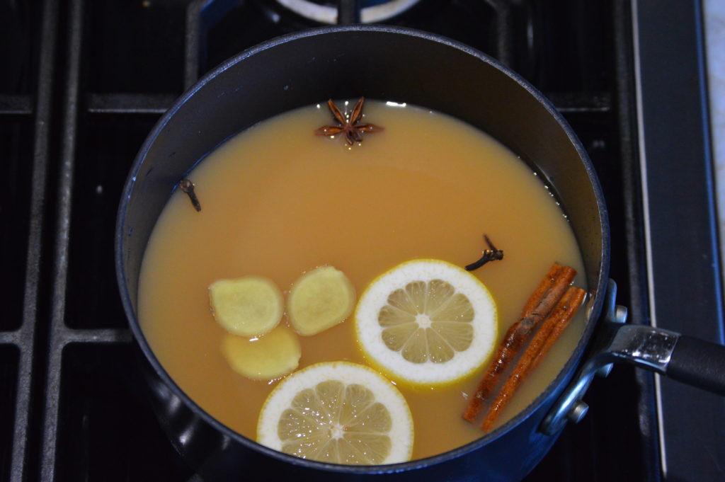 the spices and apple cider in a pot