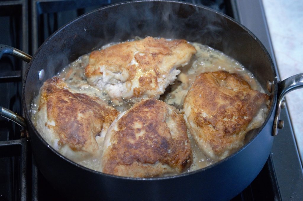 the chicken added back to the dish before being put in the oven