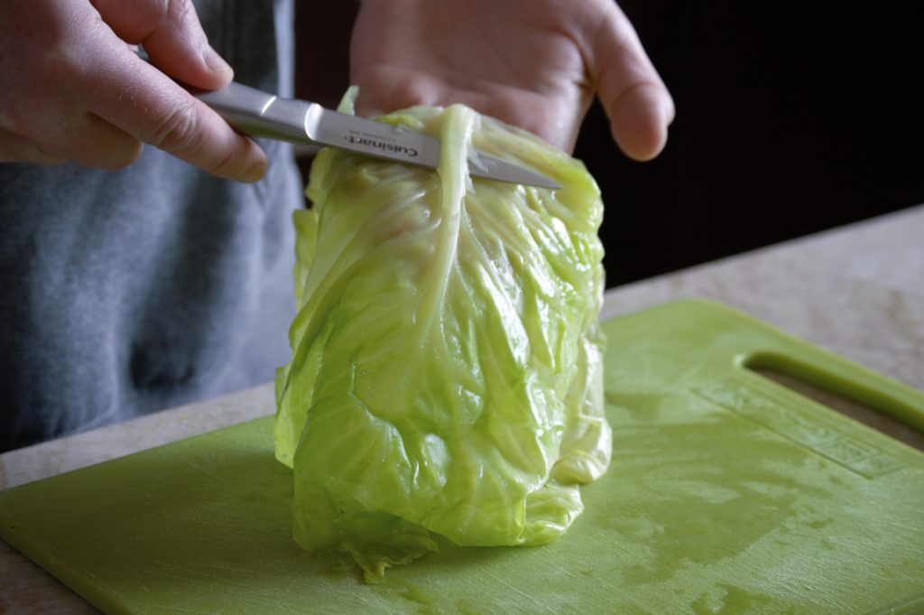 removing the outer stem of the cabbage leaf