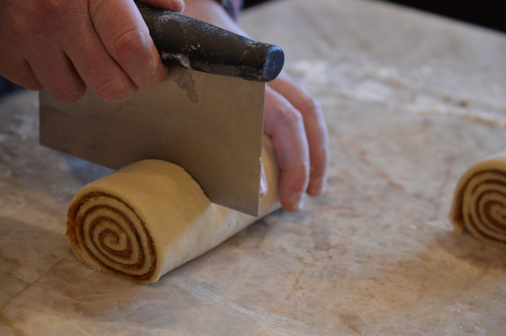 cutting the cinnamon rolls
