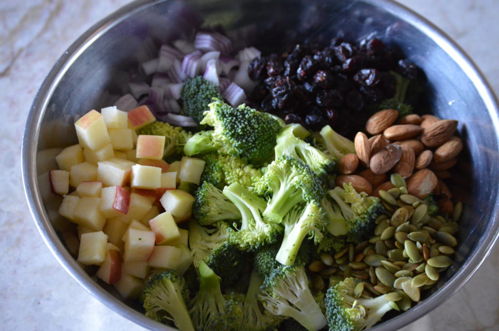 all of the ingredients for the broccoli salad in a large bowl