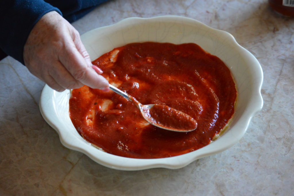 pouring sauce over the top