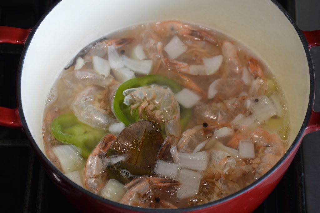 the shrimp stock simmering in a pot