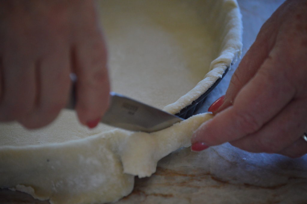cutting off excess pie crust