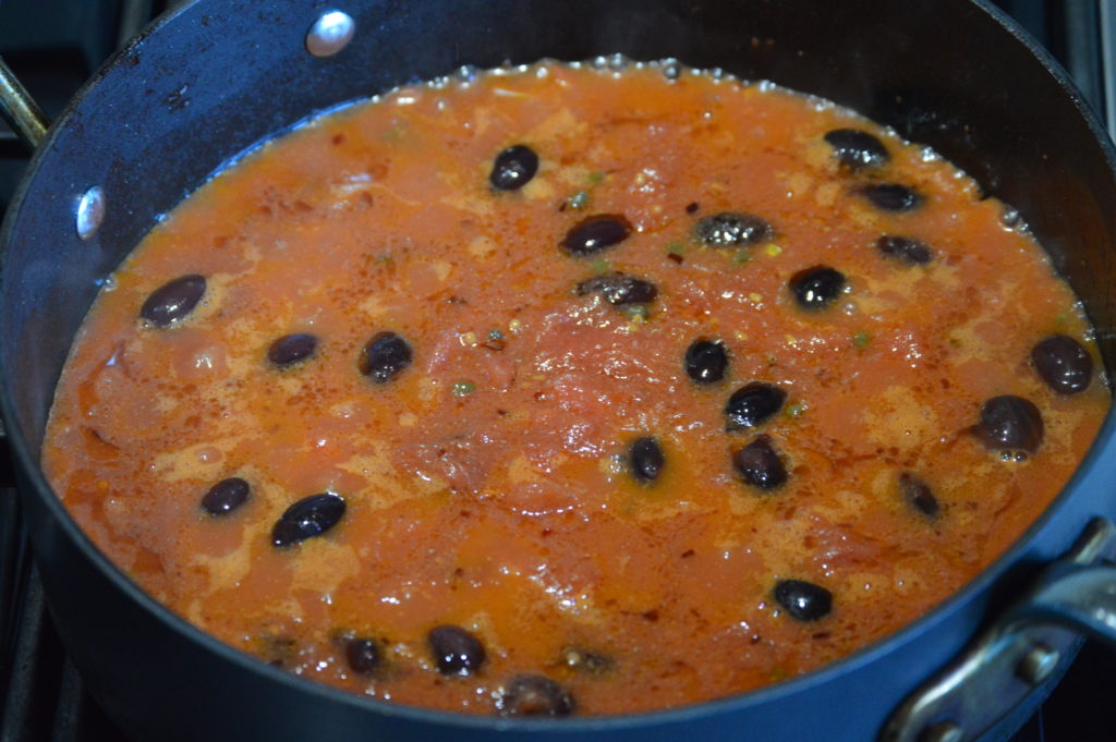 the tomato, olives, and capers added to make the sauce