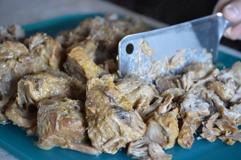 chopping up the carnitas meat