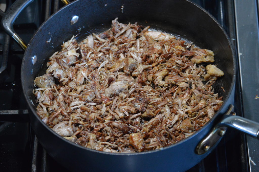 frying up the carnitas meat