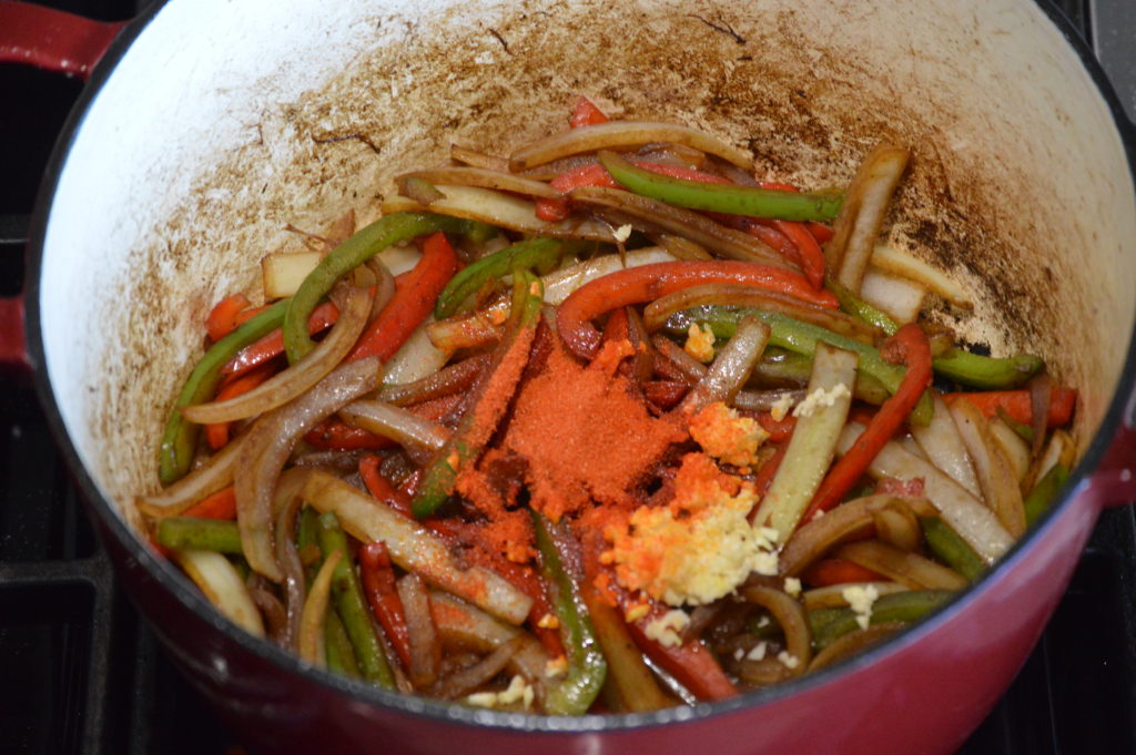 the onion bell pepper sazon and garlic in the pot