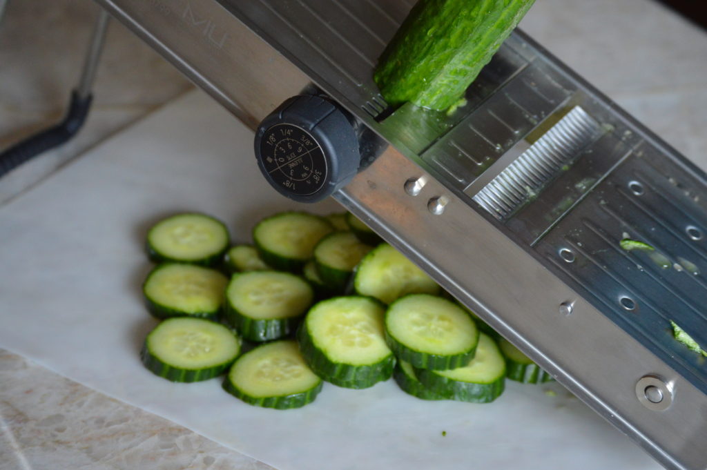 slicing up the cucumbers