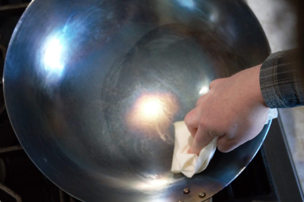 rubbing oil into the blued carbon steel wok