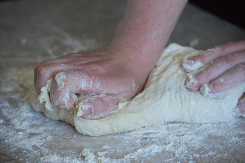 keeding the focaccia dough by hand