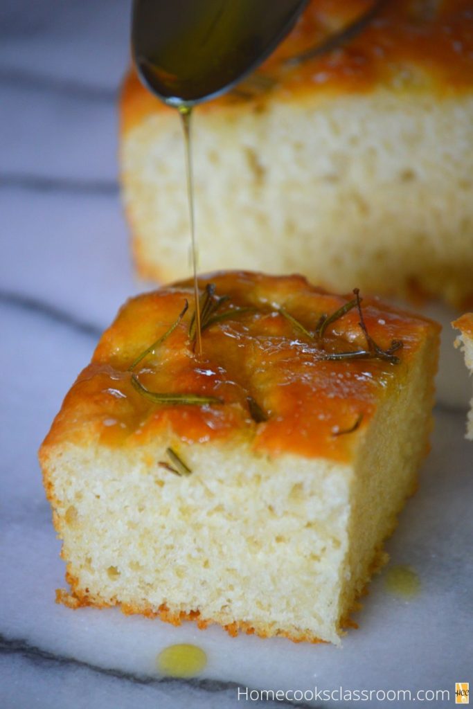 another shot of the focaccia bread with some olive oil poured over it