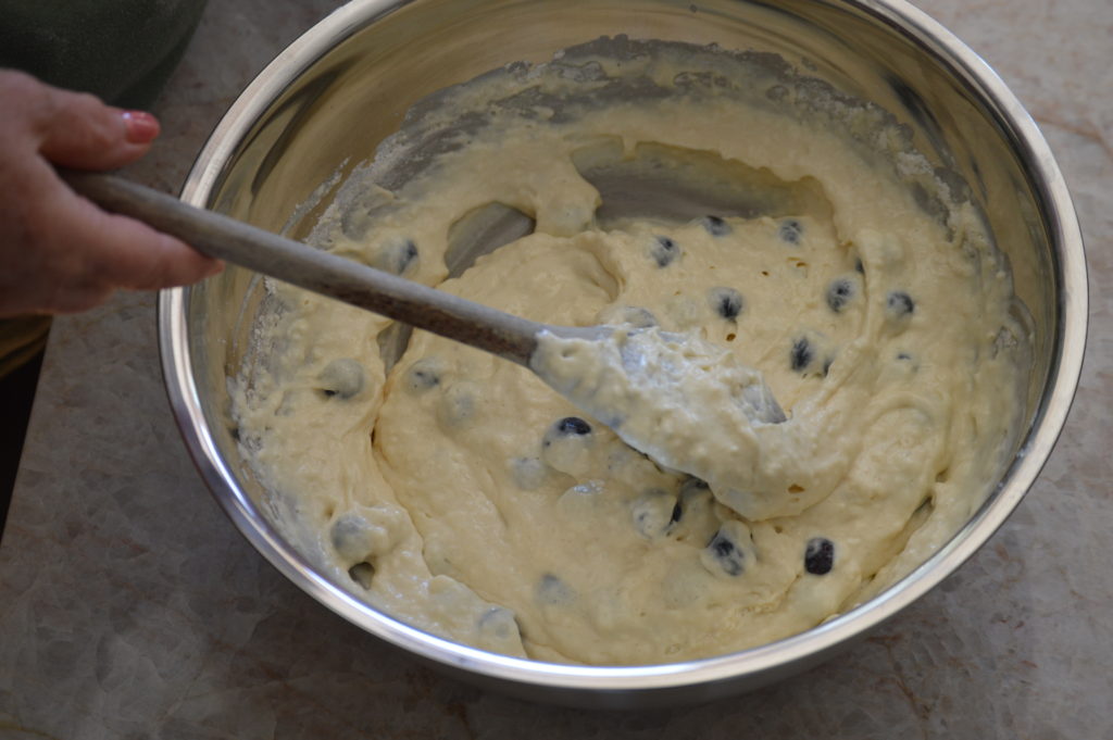 the blueberries are folded into the batter