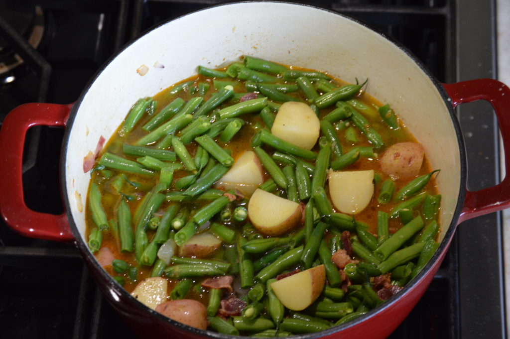 the green beans and stock is added to the pot