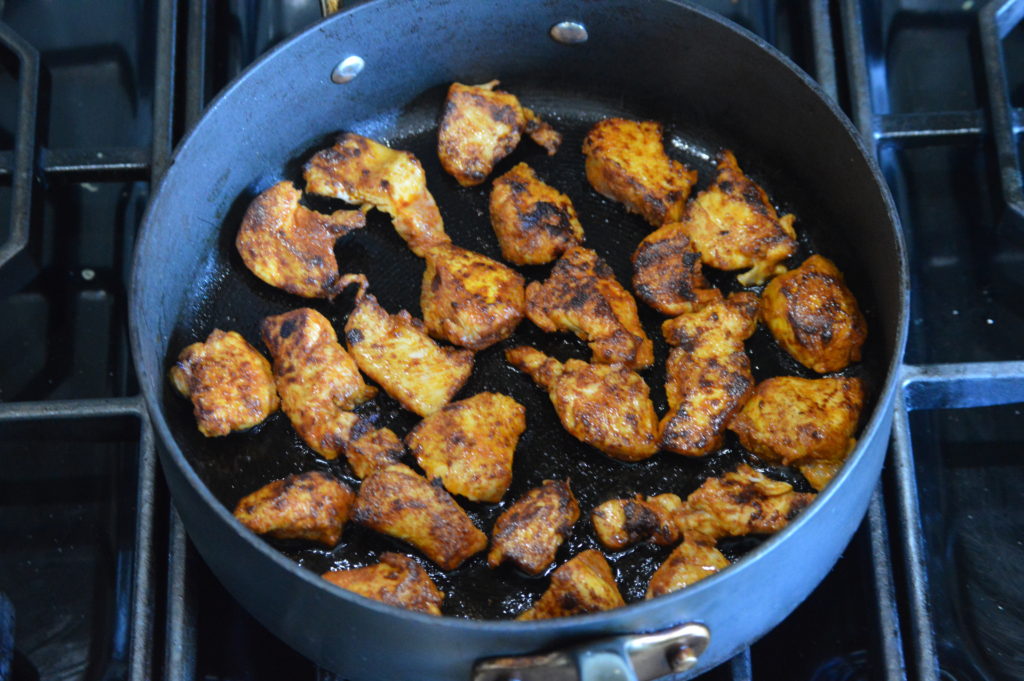 the chicken cooking in the pan