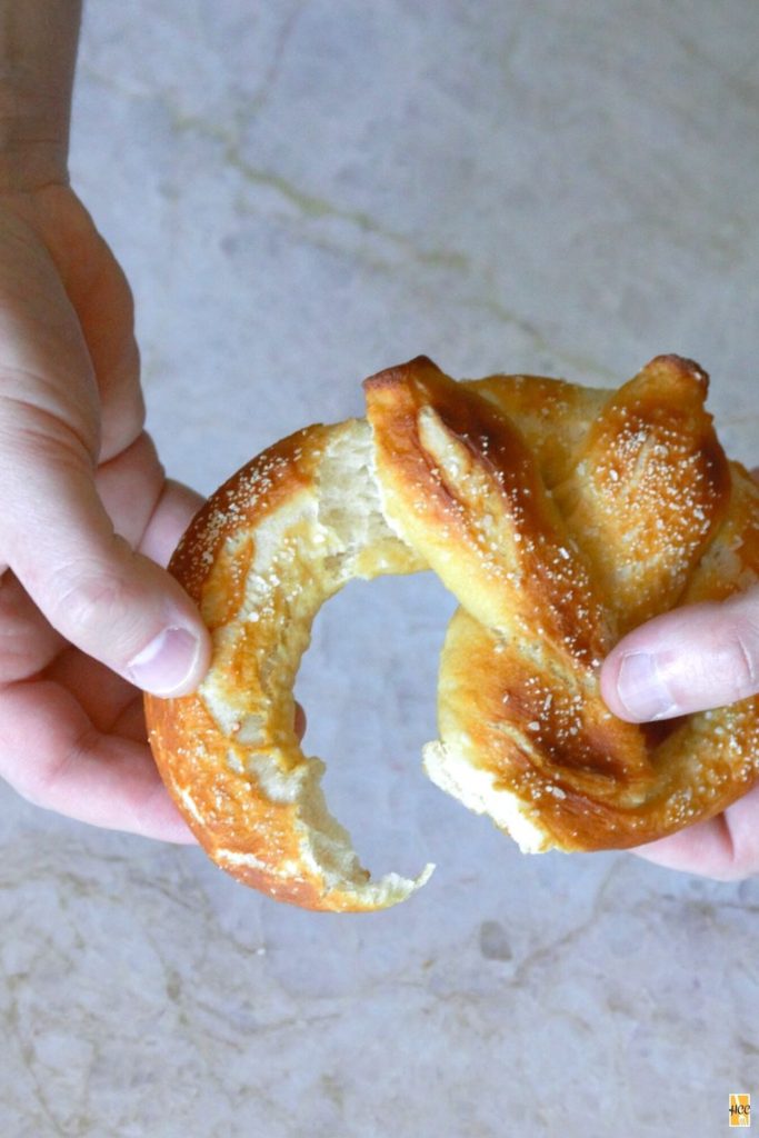 ripping into a freshly baked soft pretzel