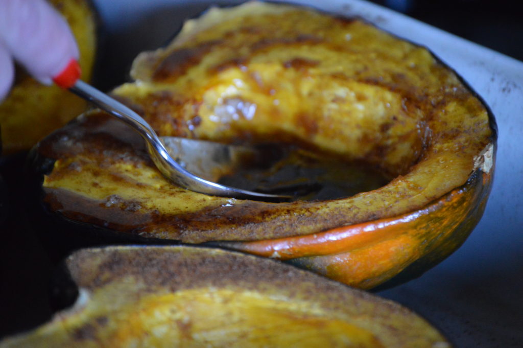 spooning the glaze over the squash