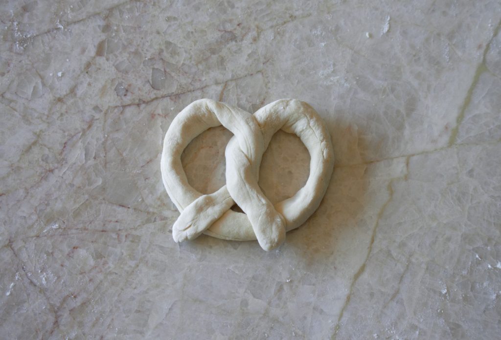 the dough is shaped into a pretzel