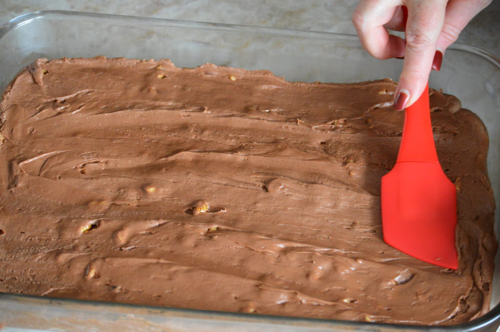 spreading the fudge out in a baking dish