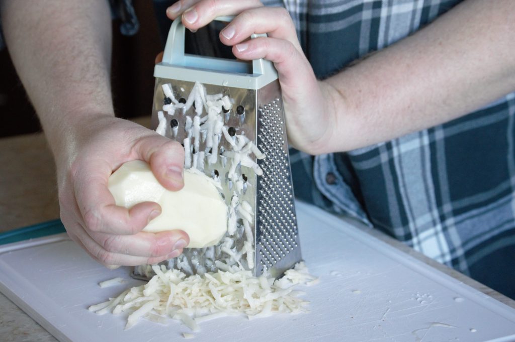 grating the potatoes and onion