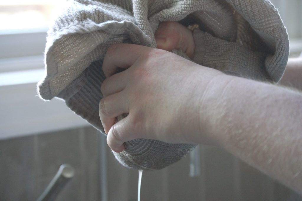 squeezing the liquid out of the potatoes and onion 