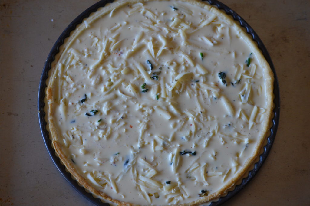 the quiche filling is poured in 
